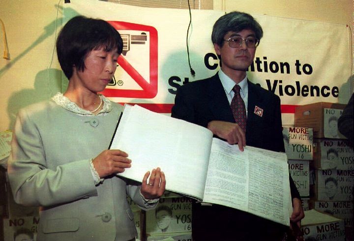 Mieko and Masaichi Hattori display a book containing some of the 1.7 million signatures they collected in Japan to petition U.S. President Bill Clinton to fight against U.S. gun violence on Nov. 16, 1993.