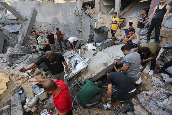 Palestinians look for survivors after an Israeli strike in Rafah, Gaza Strip, on Oct. 31, 2023.