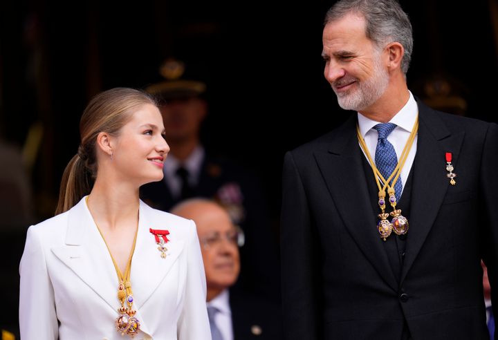 Princess Leonor looks at her father, the Spanish King Felipe VI, as they attend a military parade after swearing allegiance to the Constitution during a gala event in Madrid.