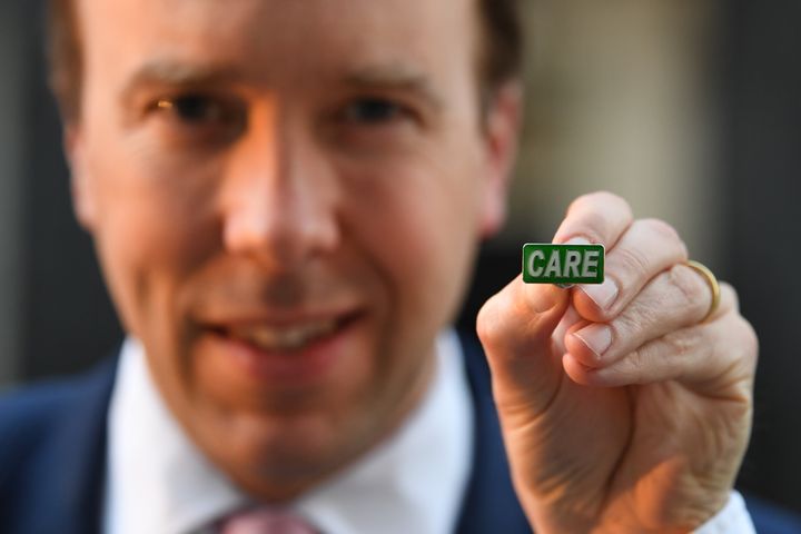 Matt Hancock showing the new 'Care' badge, described as a "badge of honour" for social care workers so they can get the same public recognition as NHS staff, in Downing Street, London.