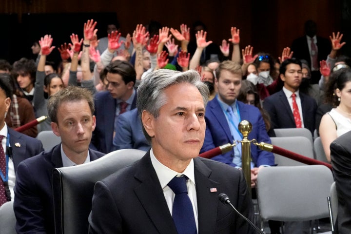 Secretary of State Antony Blinken pauses as protesters interrupt his testimony to the Senate Appropriations Committee on aid to Israel.