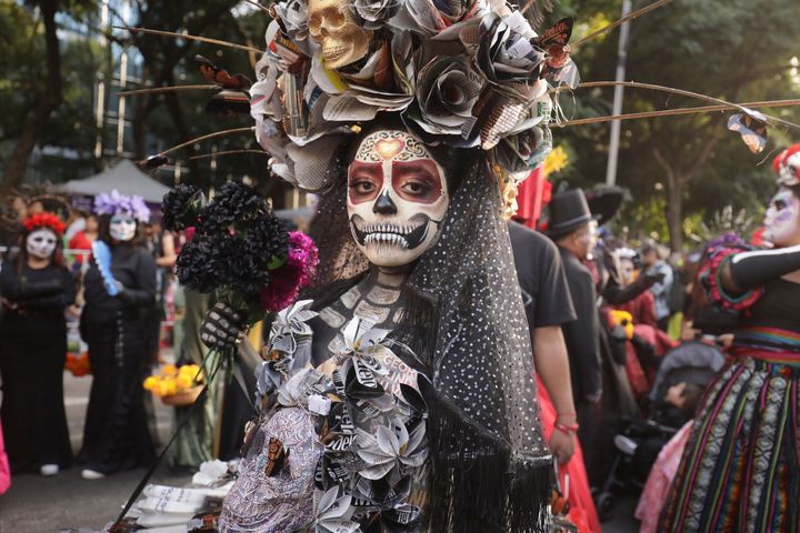 People dressed as "Catrinas" parade down Mexico City's iconic Reforma avenue during celebrations ahead of the Day of the Dead in Mexico, Sunday, Oct. 22, 2023. (AP Photo/Ginnette Riquelme)