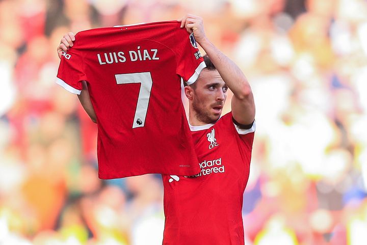 Diogo Jota of Liverpool holds the shirt of teammate Luis Díaz after scoring their first goal between Liverpool F.C. and Nottingham Forest.