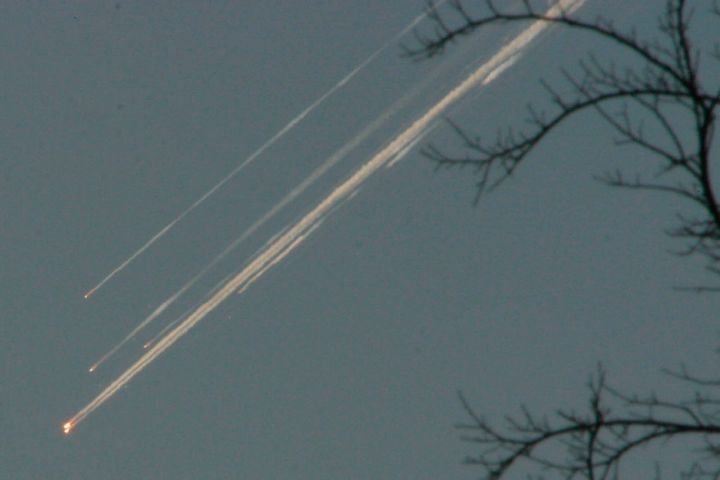 Debris from the space shuttle Columbia streaks across the Texas sky, as seen from Dallas in February 2003.