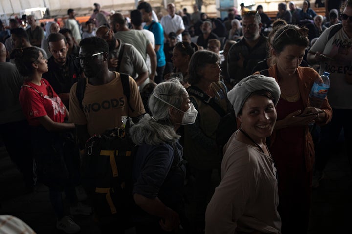 Palestinians and foreign aid workers wait to cross into Egypt at Rafah, Gaza Strip, on Wednesday, Nov. 1, 2023. (AP Photo/Fatima Shbair)