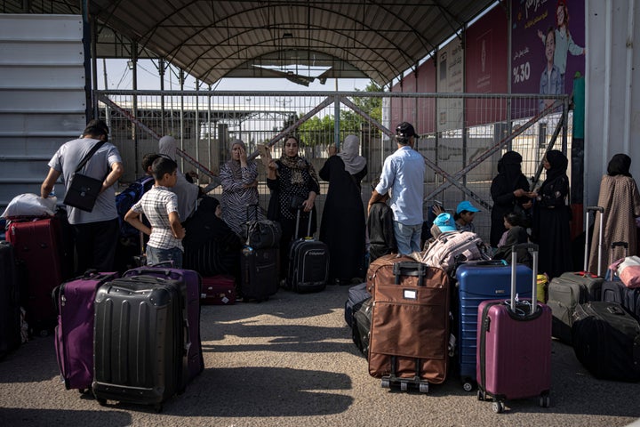 Palestinians wait to cross into Egypt at Rafah, Gaza Strip, on Nov. 1, 2023.