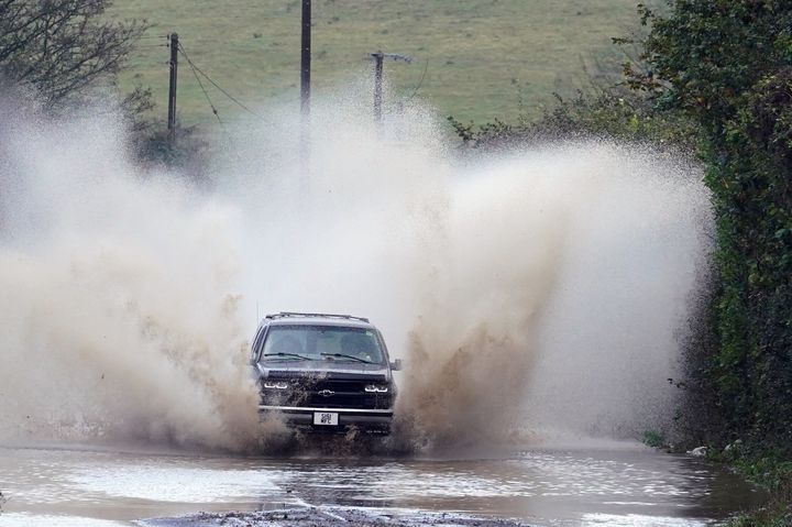 A car drives through flood water near Folkestone, Kent, as Storm Ciaran brings high winds and heavy rain along the south coast of England. 