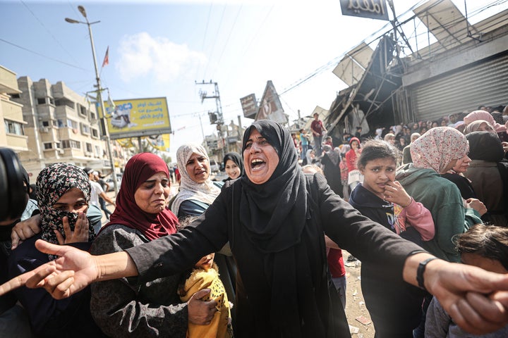 DEIR AL BALAH, GAZA - NOVEMBER 02: Civilians wait in front of a partially collapsed, still operational bakehouse in Nuseirat refugee camp in Deir al Balah, Gaza on November 02, 2023. The bakehouse, which is the only bakehouse in the camp, hit by Israeli forces. (Photo by Mustafa Hassona/Anadolu via Getty Images)