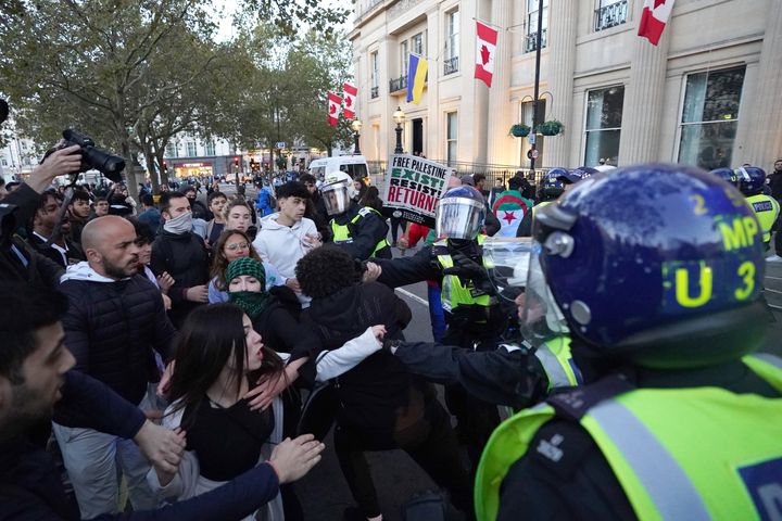 Police officers and protesters clash close to Trafalgar Square during a March for Palestine in London. Picture date: Saturday October 14, 2023.