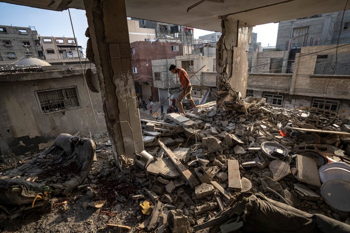 Palestinians look at the destruction after Israeli strikes on the Gaza Strip in Khan Younis, Friday, Now. 3, 2023. (AP Photo/Fatima Shbair)