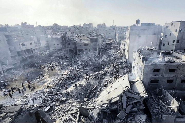 TOPSHOT - This image grab taken from AFPTV video footage shows Palestinians checking the destruction in the aftermath of an Israeli strike on the Jabalia refugee camp in the Gaza Strip, on November 1, 2023, amid ongoing battles between Israel and the Palestinian Hamas movement. Thousands of civilians, both Palestinians and Israelis, have died since October 7, 2023, after Palestinian Hamas militants based in the Gaza Strip entered southern Israel in an unprecedented attack triggering a war declared by Israel on Hamas with retaliatory bombings on Gaza. (Photo by AFP) (Photo by -/AFP via Getty Images)