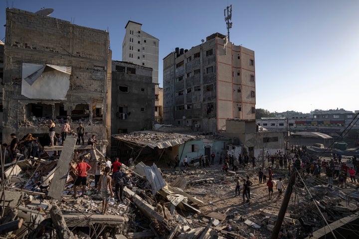 Palestinians look at the destruction after Israeli strikes on the Gaza Strip in Khan Younis, Saturday, Now. 4, 2023. (AP Photo/Fatima Shbair)