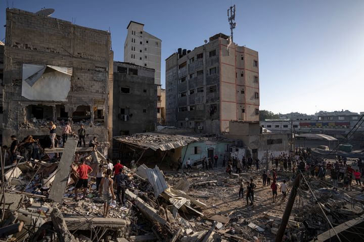 Palestinians look at the destruction after Israeli strikes on the Gaza Strip in Khan Younis, Saturday, Now. 4, 2023. (AP Photo/Fatima Shbair)