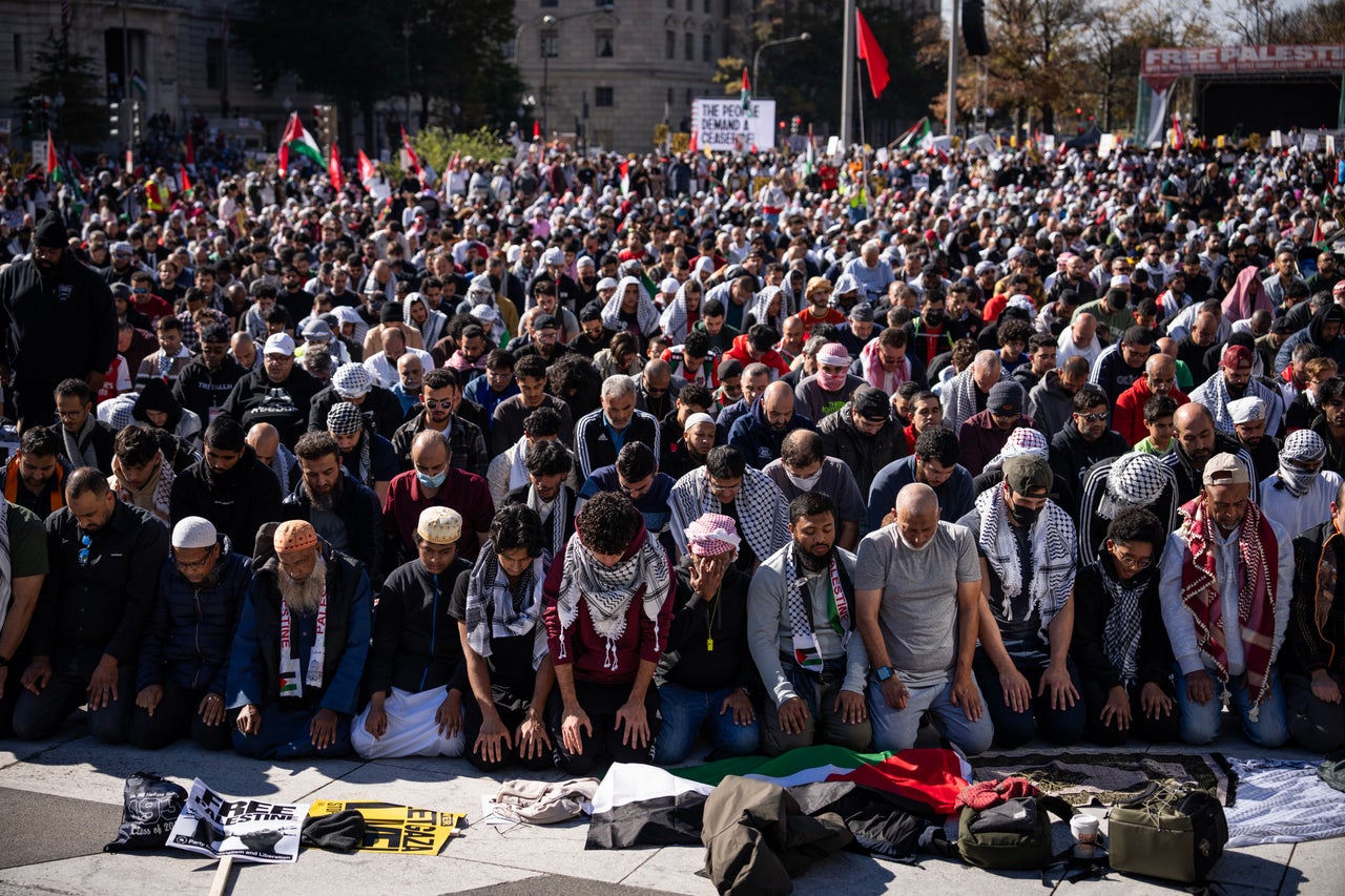 People pause for prayer during the National March on Washington to Free Palestine.