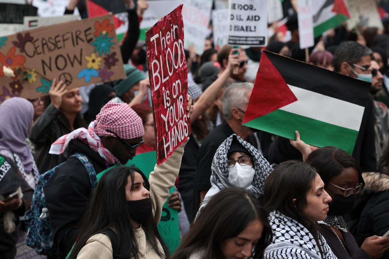 “There is blood on your hands,” reads one sign.