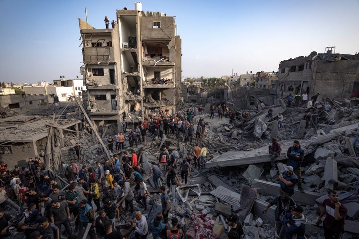 Palestinians look for survivors of the Israeli bombardment in the Maghazi refugee camp in the Gaza Strip, Sunday, Nov. 5, 2023. (AP Photo/Fatima Shbair)