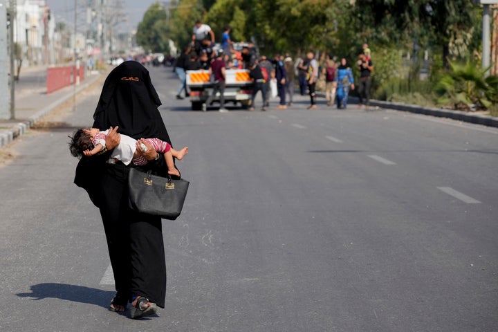 Palestinians flee the southern Gaza Strip on Salah al-Din street in Bureij on Sunday, Nov. 5, 2023. (AP Photo/Hatem Moussa)