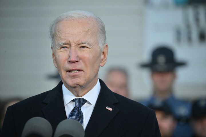 President Joe Biden speaks in Lewiston, Maine, on Friday, surrounded by first responders, nurses, and others on the front lines of the response to the Oct. 25 mass shooting there.