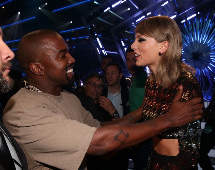 Recording artists Kanye West (L) and Taylor Swift hug during the 2015 MTV Video Music Awards.