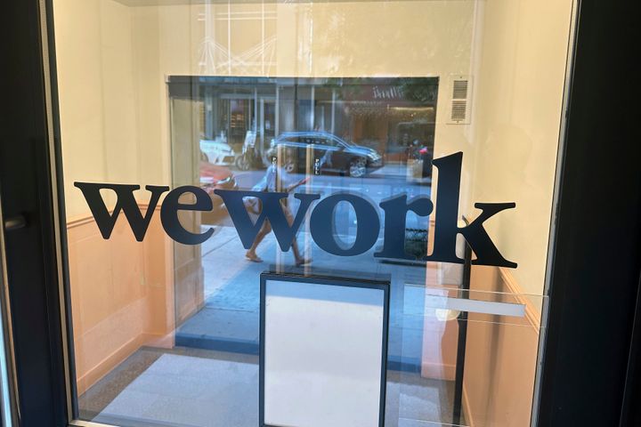 A sign for WeWork is displayed at their office in the borough of Manhattan in New York, Aug. 9, 2023. Trading in shares of WeWork were halted Monday as rumors that the office sharing company will seek bankruptcy protection.