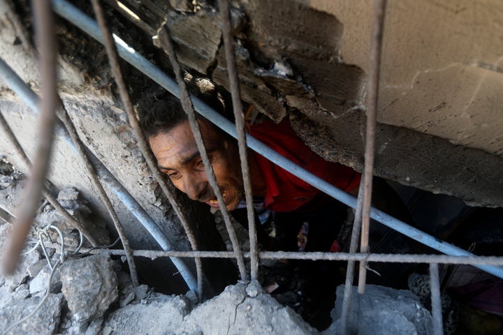 Palestinians look for survivors under the rubble of a destroyed building following an Israeli airstrike in Khan Younis refugee camp, southern Gaza Strip, on Nov. 6, 2023.