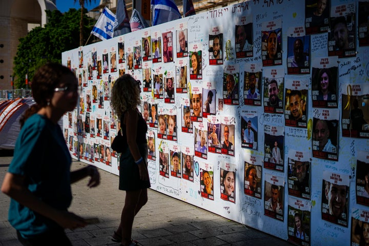 A woman looks at photos of people kidnapped during the Oct. 7 Hamas bloody cross-border attack in Tel Aviv, Israel, on Nov. 7, 2023. 