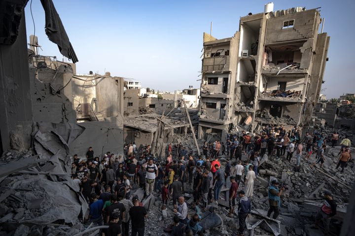 Palestinians look for survivors of the Israeli bombardment of the Gaza Strip in Khan 