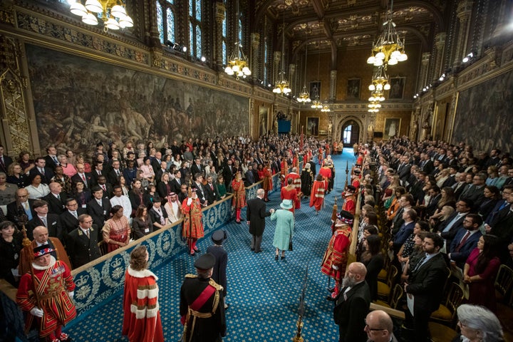 Then-Queen Elizabeth II and Prince Charles, Prince of Wales proceed through the Royal Gallery on their way to the Lord's Chamber to attend the State Opening of Parliament on December 19, 2019 in London, England.