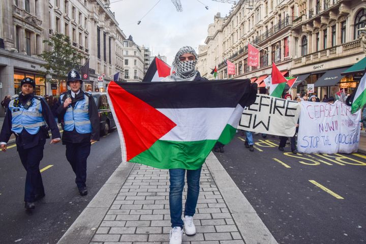 A protester holds a Palestinian flag during the demonstration in Regent Street