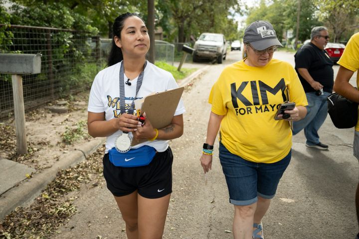 Mayoral candidate Kimberly Mata-Rubio (left) with campaign manager Laura Barberena canvass a neighborhood on Oct. 21 in Uvalde, Texas.