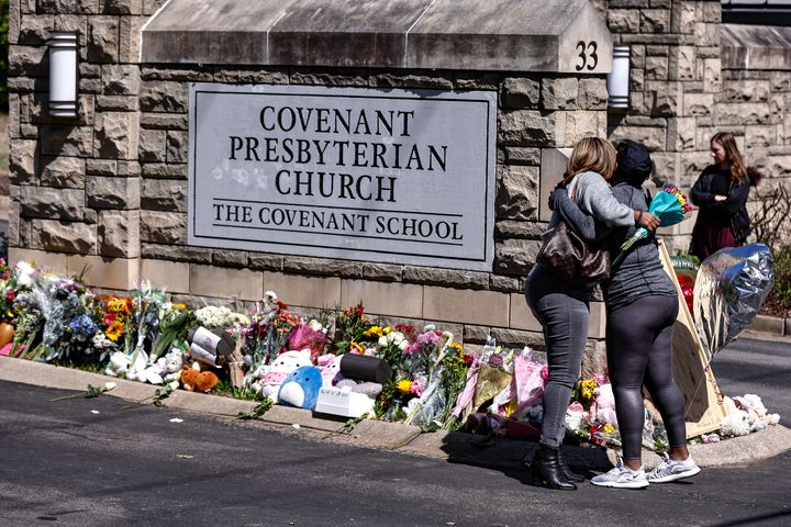 Two women hug near a memorial at the entrance to The Covenant School, in Nashville, Tennessee, on March 29. The Tennessee Court of Appeals has heard arguments on whether Tennessee law gives the parents of school shooting victims the right to have a say over which police records are released to the public.