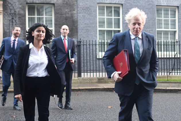 LONDON, ENGLAND - DECEMBER 15: Prime Minister Boris Johnson leaves Downing Street for a Cabinet Meeting at the FCO with political advisor Munira Mirza (L), on December 15, 2020 in London, England. Ministers may review the Christmas coronavirus guidelines that allow three households to meet inside for a five-day period, after a spike in cases across London and the South East that sees the area moving into Tier 3 from 00:01 Wednesday. (Photo by Peter Summers/Getty Images)