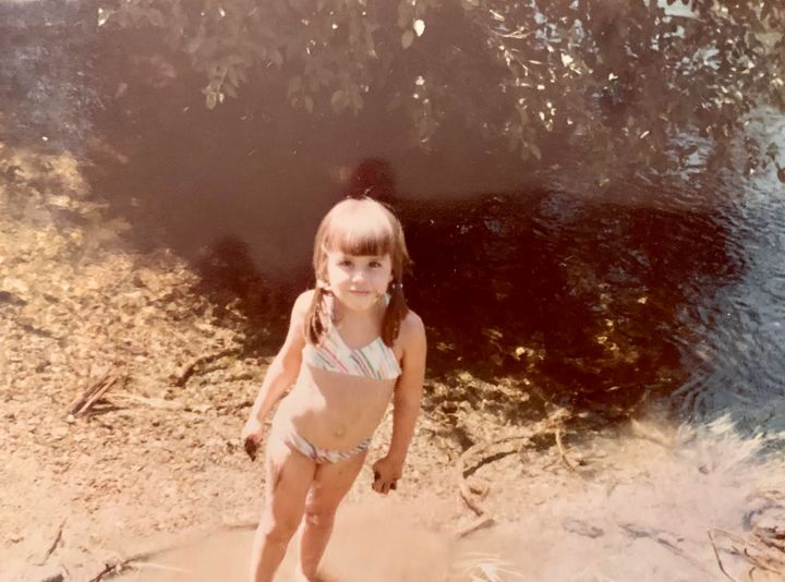 The author by a mountain creek on a camping trip, circa 1980.