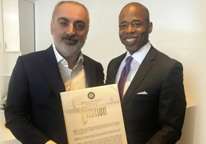 Then-Brooklyn Borough President Eric Adams presented a certificate to Turken Foundation board member Memiş Yetim in 2018.