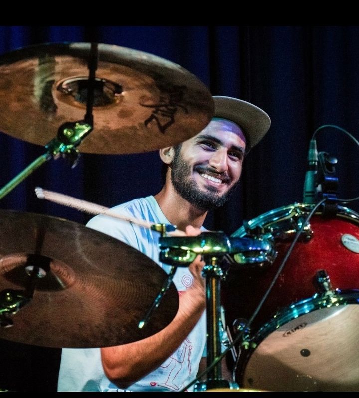 Eric smiling behind the drum kit