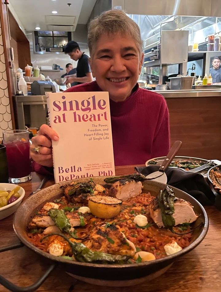 The author celebrates the publication of "Single at Heart," her book, with friends at a Spanish restaurant.