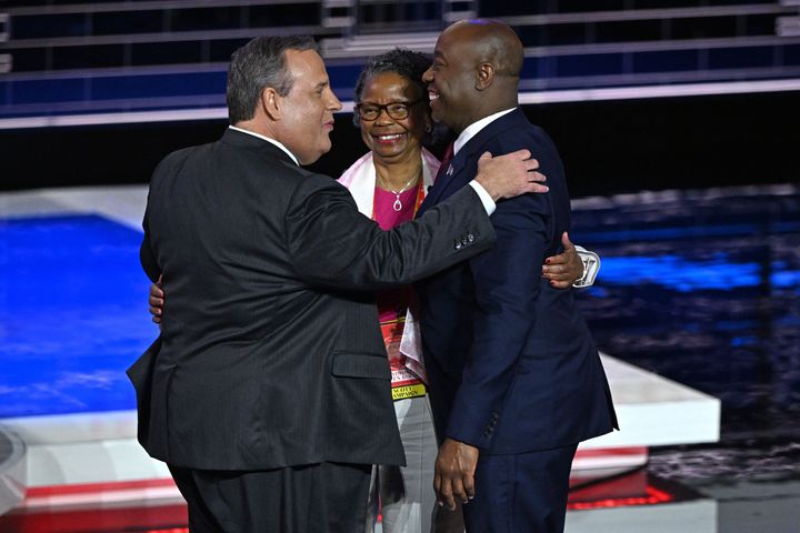 Former New Jersey Gov. Chris Christie (left) greets Sen. Tim Scott (S.C.) and his mother, Frances Scott, following the third Republican presidential primary debate Wednesday in Miami.