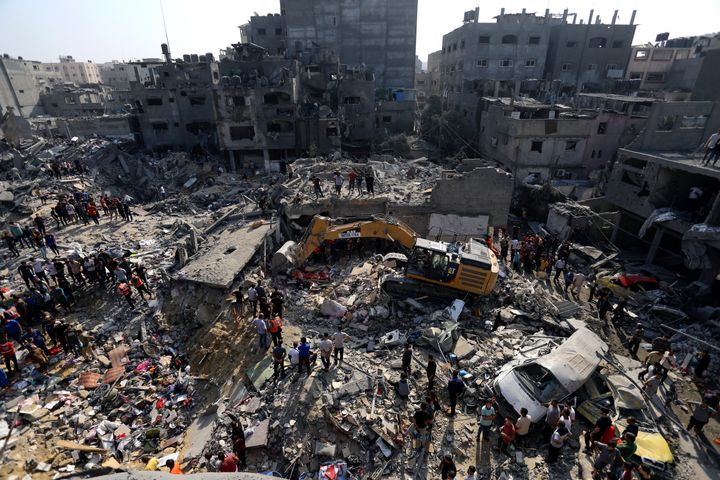 Palestinians look for survivors under the rubble of destroyed buildings following Israeli airstrikes in Jabaliya refugee camp, northern Gaza Strip.