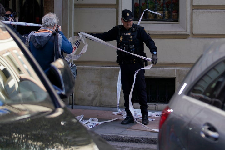 A police officer cordons off the area after a shooting in Madrid, Spain, Thursday, Nov. 9, 2023. Spanish police say that veteran Spanish right-wing politician Alejandro Vidal-Quadras has been taken to a hospital in Madrid after being shot in a street in the capital. (AP Photo/Andrea Comas)