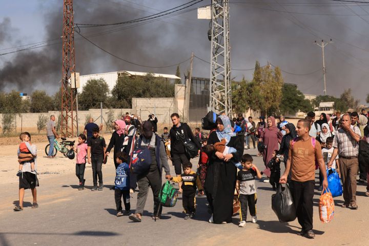 Palestinians families fleeing Gaza City and other parts of northern Gaza towards the southern areas, walk along a road on November 10, 2023 amid ongoing battles between Israel and Hamas. (Photo by MAHMUD HAMS/AFP via Getty Images)