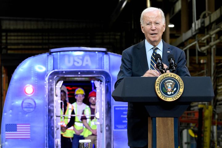 Workers look on as US President Joe Biden delivers remarks on his "Bidenomics" economic agenda and his Investing in America agenda at an Amtrak facility in New Castle County, Delaware, on November 6, 2023. (Photo by ANDREW CABALLERO-REYNOLDS / AFP) (Photo by ANDREW CABALLERO-REYNOLDS/AFP via Getty Images)