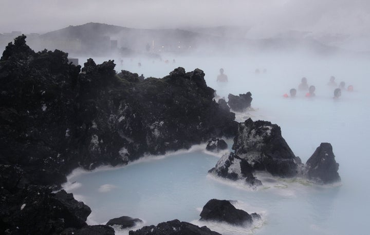 In this Feb. 21, 2006 file photo Tourists relax in the Blue Lagoon geothermal spa, Iceland on Feb. 21,2006. The geothermal spa Blue Lagoon has temporarily closed after a series of earthquakes have put Iceland's southwestern corner on volcanic alert, reaching a state of panic on Thursday when a magnitude 5.0 earthquake occurred just after midnight.