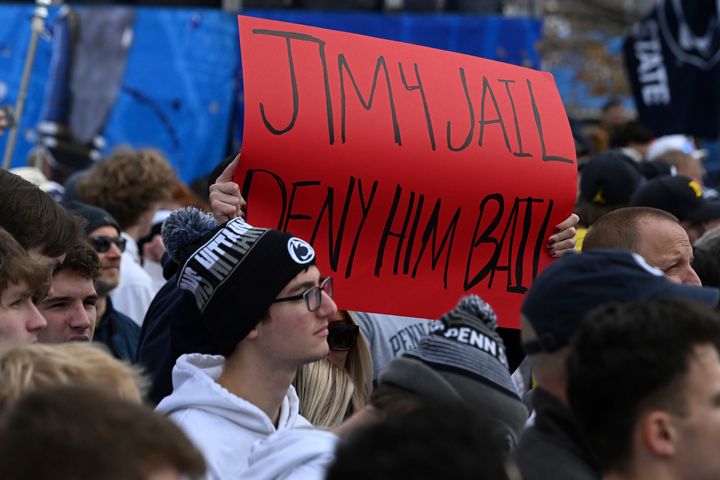 Fans display a sign about Michigan head coach Jim Harbaugh outside of Beaver Stadium before an NCAA college football game against Penn State, Saturday, Nov.11, 2023, in State College, Pa. (AP Photo/Barry Reeger)