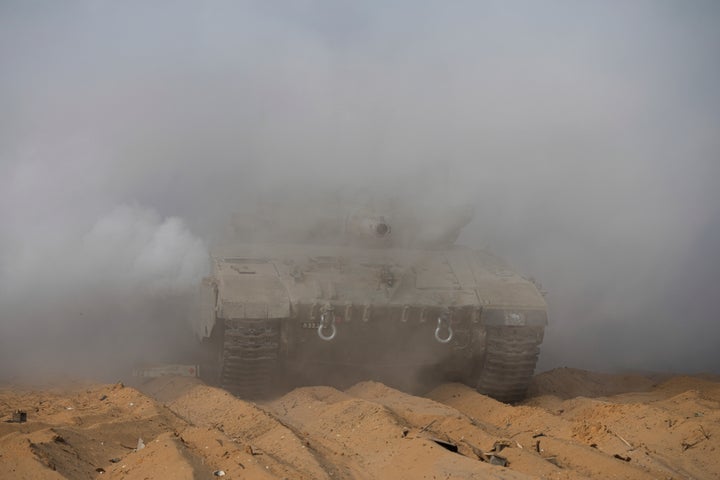 Israeli tanks manoeuvre near the Israeli-Gaza border, southern Israel, Monday, Nov. 13, 2023. (AP Photo/Tsafrir Abayov)