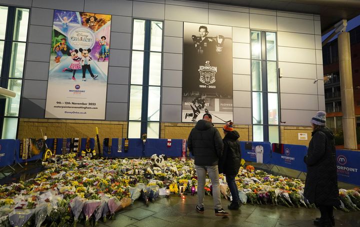 Fans look at floral tributes for Nottingham Panthers' ice hockey player Adam Johnson outside of the Motorpoint Arena in Nottingham, England, on November 4.