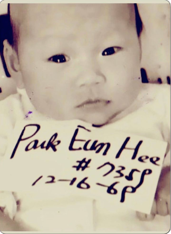 The author as a baby wearing a sign with a name picked for her by the Korean Orphanage.