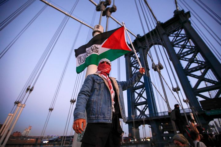 Demonstrators hold Palestinian flags as they march through the Manhattan Bridge during a rally supporting Palestinians in New York City on Nov. 7.