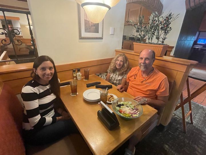 The author and her parents celebrating a recent writing success at the Olive Garden where she used to work.