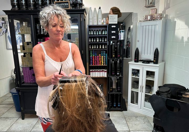 Christine Geiger cuts a customer's hair at her salon in Traverse City, Michigan. 