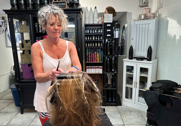 Christine Geiger cuts a customer's hair at her salon in Traverse City, Michigan.
